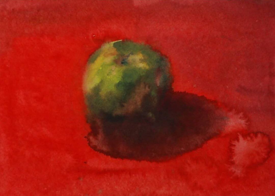 Green apple on a red background